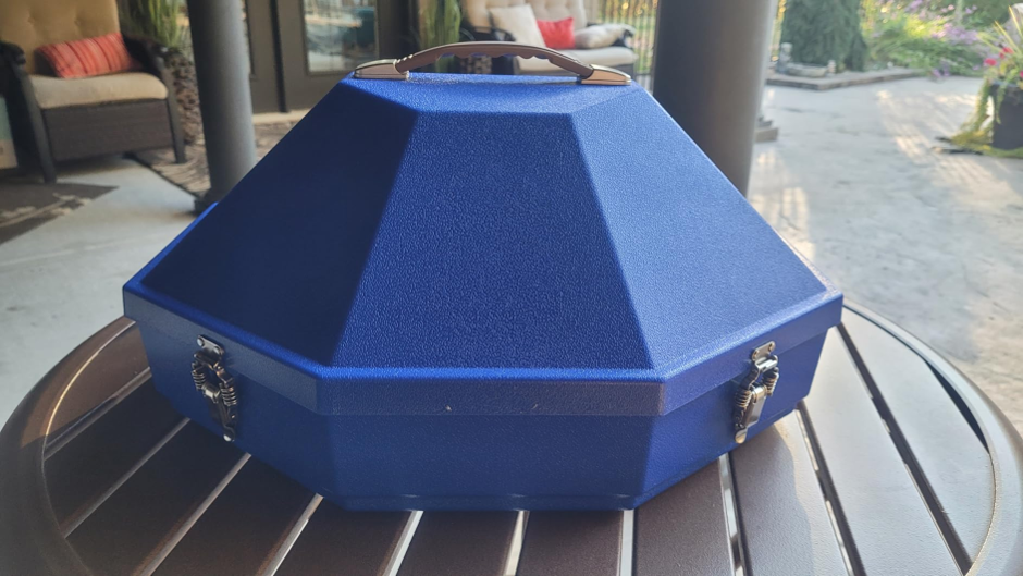 Jaybird's blue Mavericrest case closed on a patio table